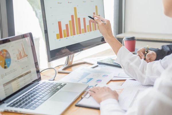 Business adviser analyzing financial figures denoting the progress Internal Revenue Service checking document. Audit concept