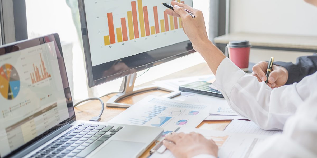 Business adviser analyzing financial figures denoting the progress Internal Revenue Service checking document. Audit concept